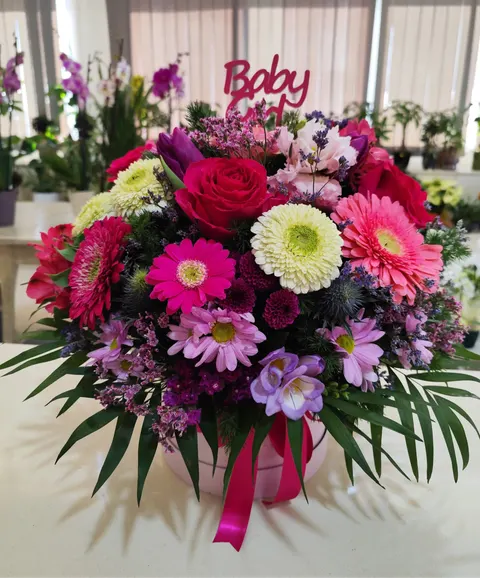 Pink floral gift box with chrysanthemums, roses, alstroemeria, limonium, and gerberas, elegant bouquet for baby girl