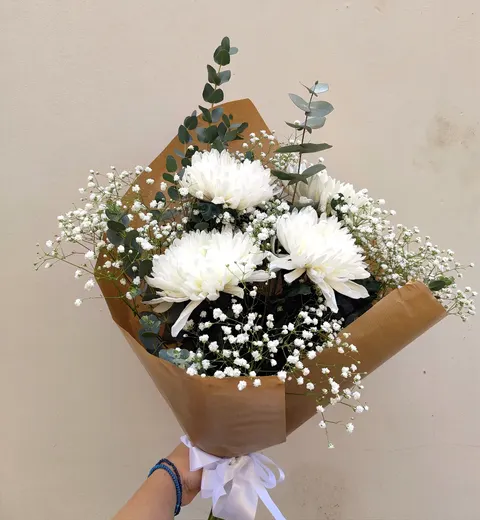 Elegant bouquet with chrysanthemums, Anastasia chrysanthemum, eucalyptus, and gypsophila, soft seasonal floral arrangement.