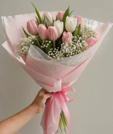 Pastel tulip bouquet with pink and white tulips and gypsophila.