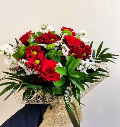 Rose and chrysanthemum bouquet with fresh mixed flowers and greenery.