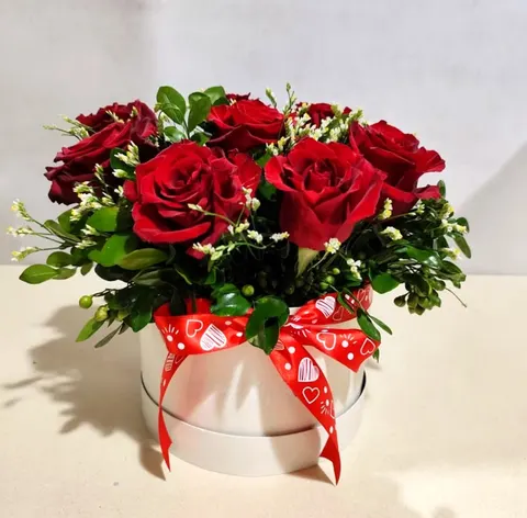 Luxury rose arrangement in a white stylish box with roses, statice and greenery